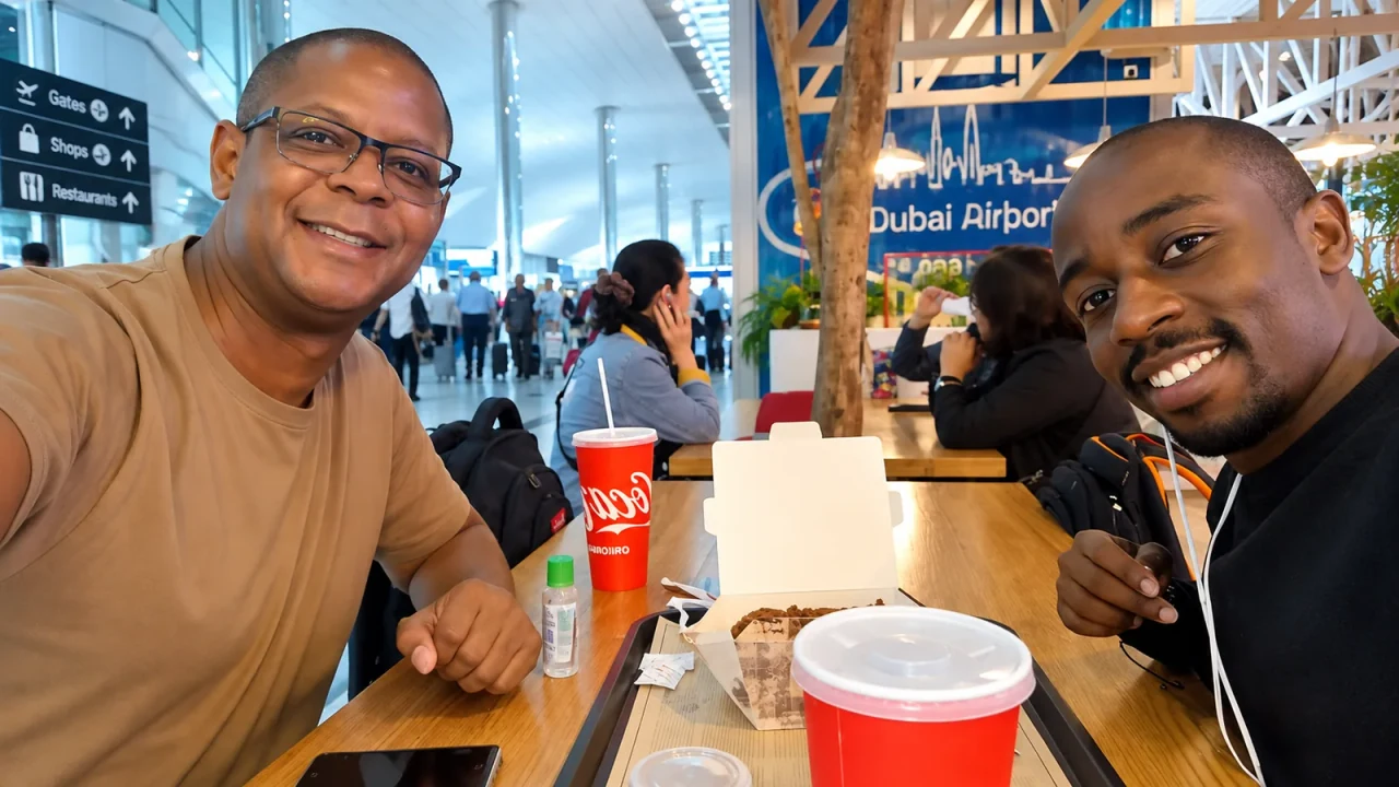 Two people seated together at an airport café.